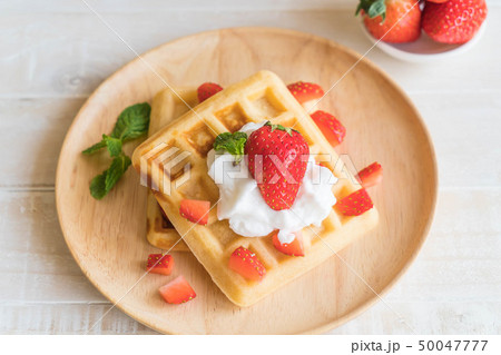 waffle with strawberry on wood waffle with strawberry on wood 50047777