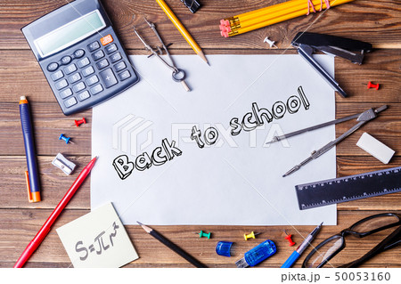 Album sheet with text - back to school and student material on wooden table. Album sheet with text - back to school and student material on wooden table. 50053160