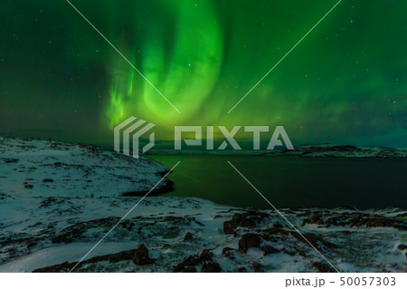 Northern Lights on the shore of the Arctic Ocean. Northern Lights on the shore of the Arctic Ocean. 50057303