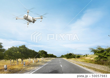 White drone with camera flying above the street 50057983