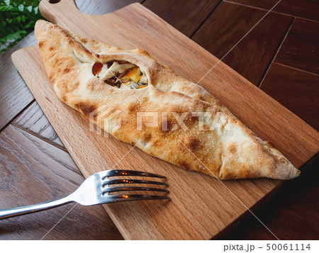 Baked bun in the shape of a boat with mozzarella Baked bun in the shape of a boat with mozzarella 50061114