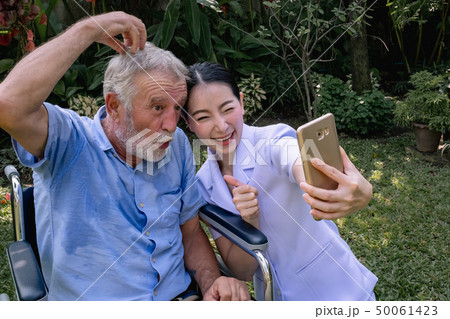 senior man happiness sitting on wheelchair with 50061423
