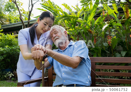 senior man happiness and smiling nurse, takes care 50061752