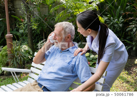 senior man happiness sitting with smiling nurse, 50061786