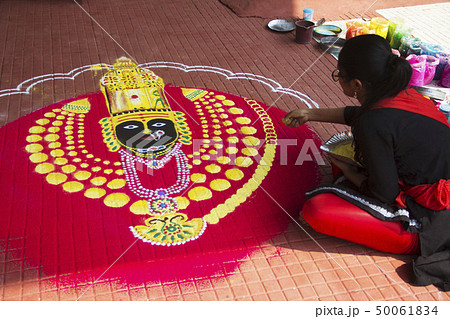 Young girl drawing rangoli of goddess Durga, Pune Young girl drawing rangoli of goddess Durga, Pune 50061834