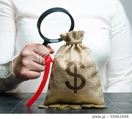 Female hand holds magnifying glass  50062688
