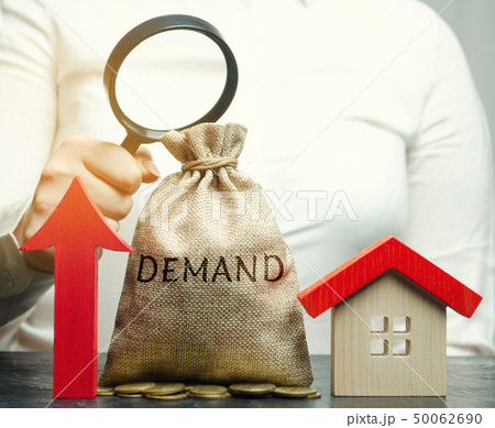 A female hand is holding a magnifying glass  50062690