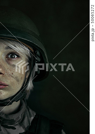 Portrait of young female soldier 50065272