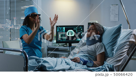Doctor using VR headset during discussing diagnosis Doctor using VR headset during discussing diagnosis 50066420