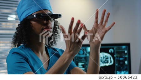 Doctor using VR headset during discussing diagnosis Doctor using VR headset during discussing diagnosis 50066423