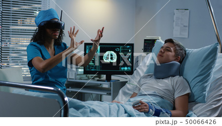 Doctor using VR headset during discussing diagnosis 50066426
