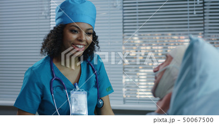Doctor showing brain scan image to patient Doctor showing brain scan image to patient 50067500