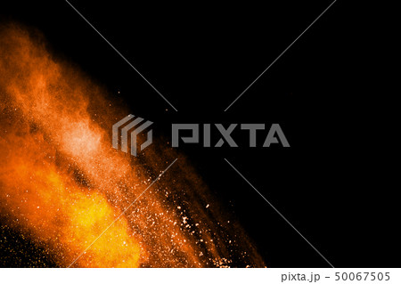 Orange powder explosion on black background. Orange powder explosion on black background. 50067505