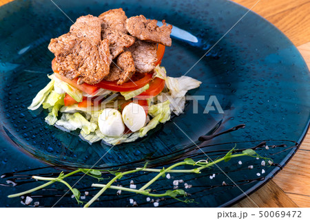 Italian food background. Mozzarella cheese, fresh basil leaves, tomatoes, olive oil, meat on the Italian food background. Mozzarella cheese, fresh basil leaves, tomatoes, olive oil, meat on the 50069472