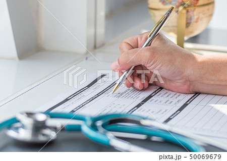 Doctor writing on medical health care record 50069679