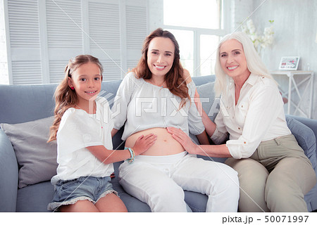 Pregnant woman feeling happy spending time with her family Pregnant woman feeling happy spending time with her family 50071997