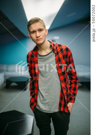 Male teenager in cinema hall before the showtime 50072002