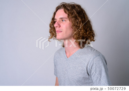Face of young handsome man with curly hair thinking Face of young handsome man with curly hair thinking 50072729