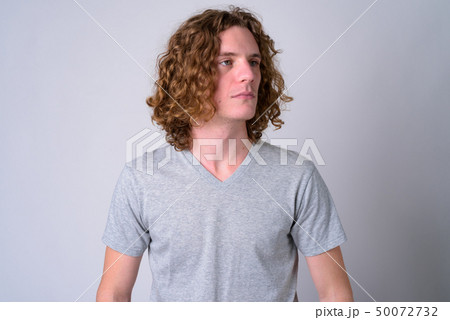 Face of young handsome man with curly hair thinking Face of young handsome man with curly hair thinking 50072732