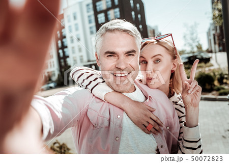 Joyful happy man taking a selfie with his wife Joyful happy man taking a selfie with his wife 50072823
