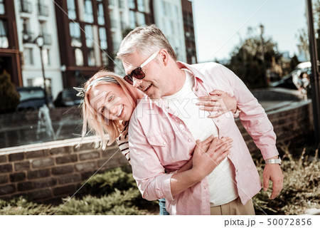 Positive nice woman standing behind her husband Positive nice woman standing behind her husband 50072856