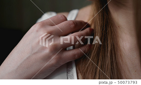 Hands of woman undressing white bra 50073793