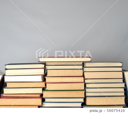stack of different books on a gray background 50075410