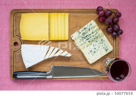 Tree kind of sliced cheese, red wine, red gpapes 50077659