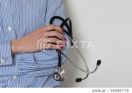 Doctor holding stethoscope Doctor holding stethoscope 50080779