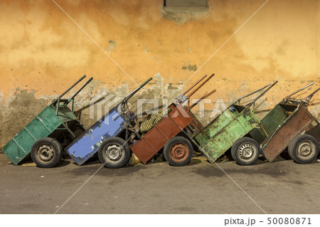 Row of carts against weathered wall Row of carts against weathered wall 50080871
