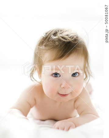 Baby girl lying on her front 50081067