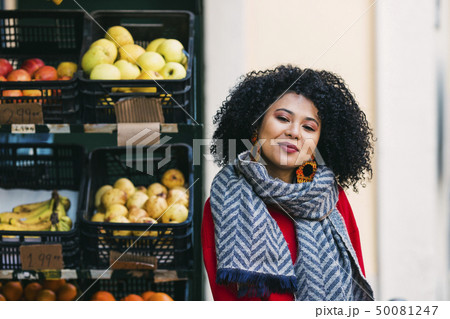 Young woman by crates of fruit 50081247