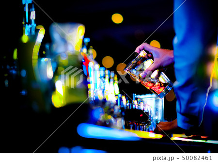 Bartender making alcohol cocktail at bar counter 50082461