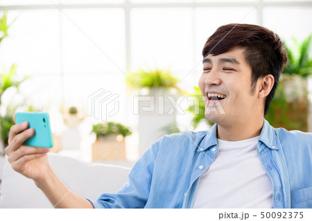man watch video with phone man watch video with phone 50092375