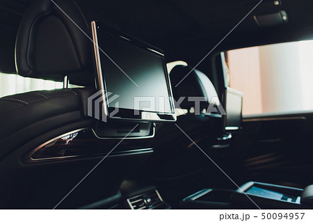 Car inside. Interior of prestige luxury modern car. Three TV displays for passenger with media 50094957