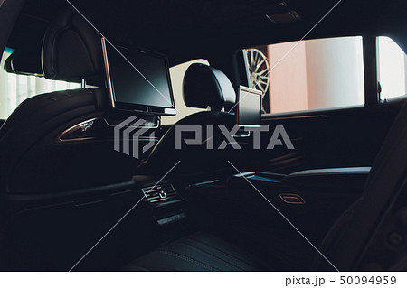 Car inside. Interior of prestige luxury modern car. Three TV displays for passenger with media 50094959