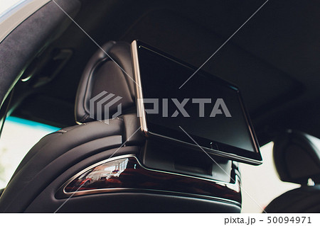 Car inside. Interior of prestige luxury modern car. Three TV displays for passenger with media Car inside. Interior of prestige luxury modern car. Three TV displays for passenger with media 50094971