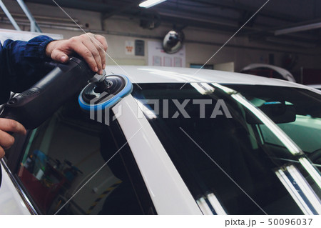 Car detailing - Hands with orbital polisher in auto repair shop. Selective focus. Car detailing - Hands with orbital polisher in auto repair shop. Selective focus. 50096037