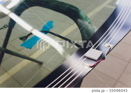 Automobile car windshield or windscreen service concept in auto service station garage. 50096045
