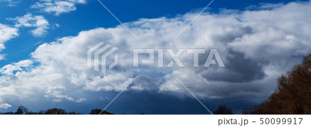 Panorama of the sky with a white cloud. 50099917