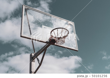 Basketball hoop against cloudy sky 50101256