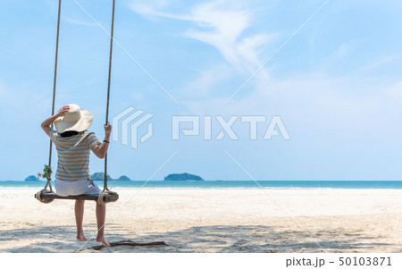 Summer beach holiday vacation with girl on swing Summer beach holiday vacation with girl on swing 50103871