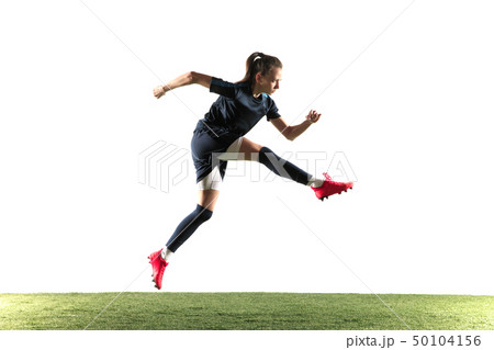 Female soccer player kicking ball isolated over white background 50104156