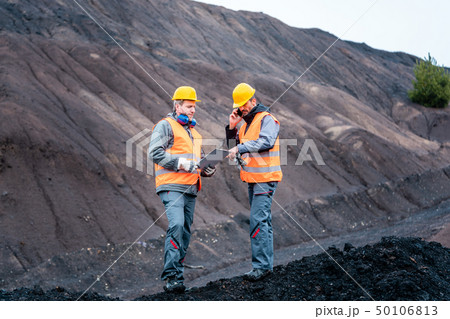 Workers in open-cast mining operation pit 50106813
