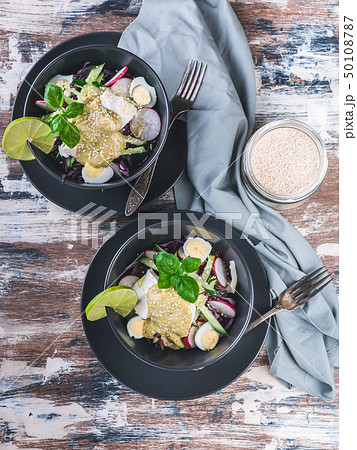 Top view fresh vegetable salad in a dark bowl. Top view fresh vegetable salad in a dark bowl. 50108787