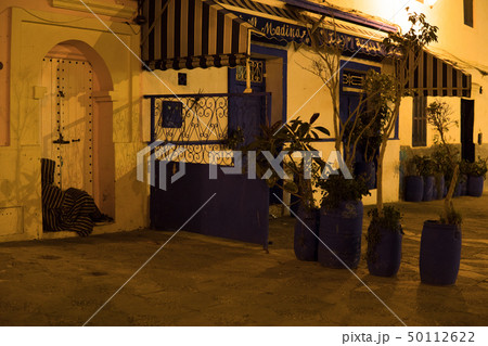Man in Traditional moroccan djellaba walking on the street of Asilah Medina, on Atlantic Coast in 50112622