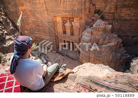 Asian man traveler sitting in Petra, Jordan 50118889