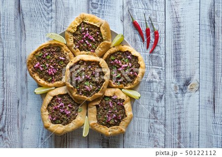 Open meat pies on a black background. Top view. 50122112