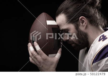 Close up portrait of American Football Player with ball Close up portrait of American Football Player with ball 50122479