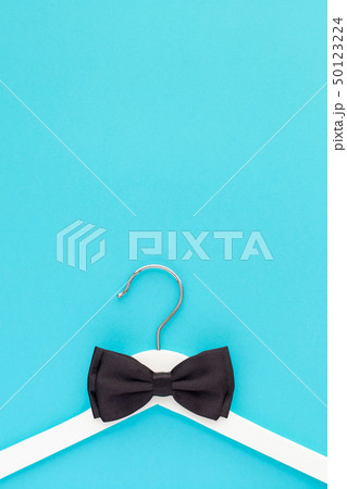 White wooden hangers on blue background 50123224